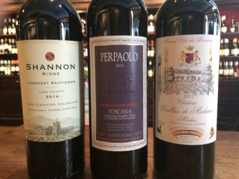 Three bottles of red wine from California, Italy, and France